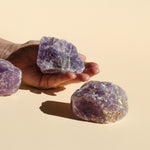 One large Amethyst Chunk on the palm of a hand