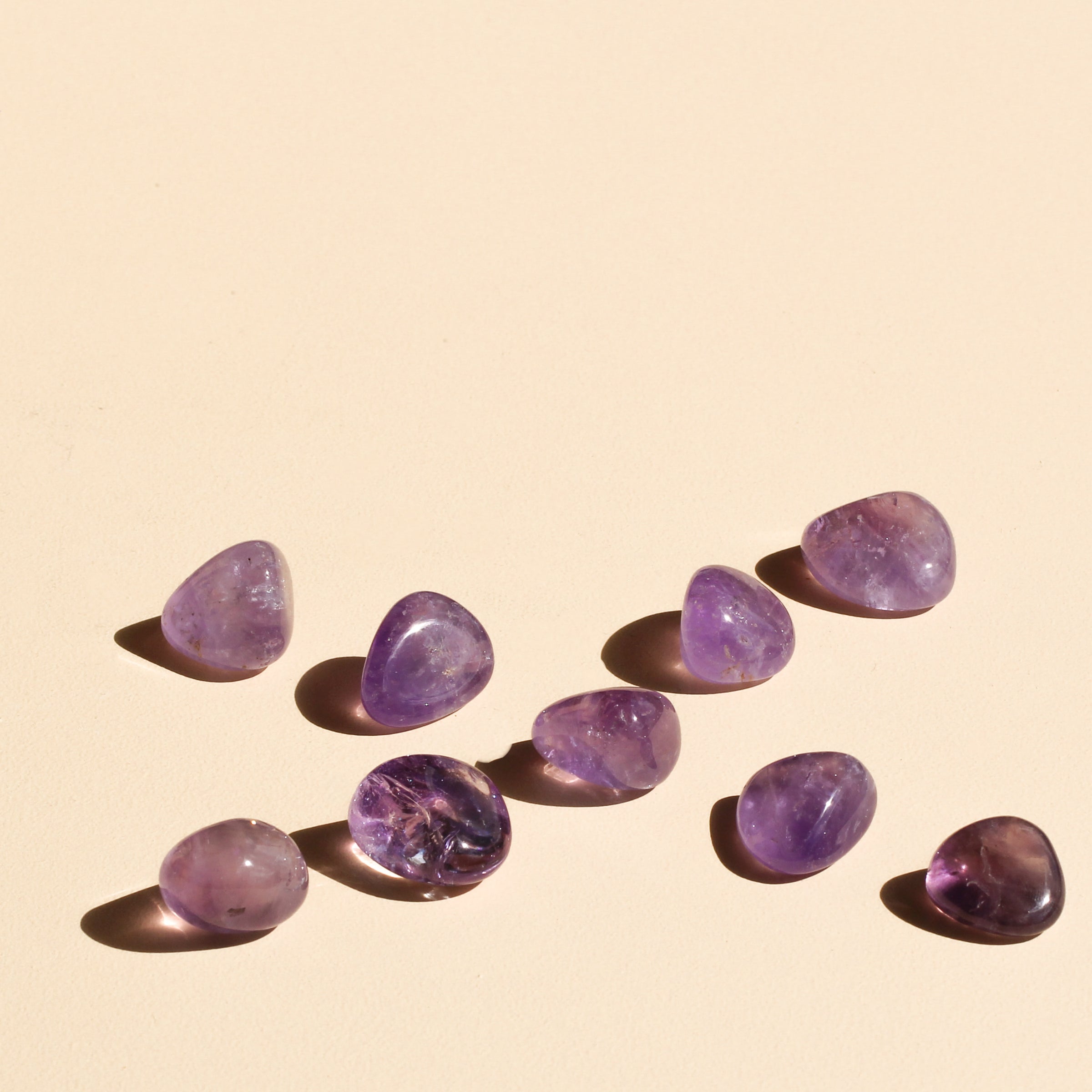 Amethyst tumbles arranged in intersecting diagonals