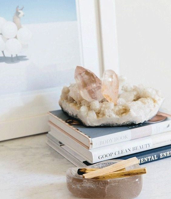 Crystals placed on a holder above a pile of books