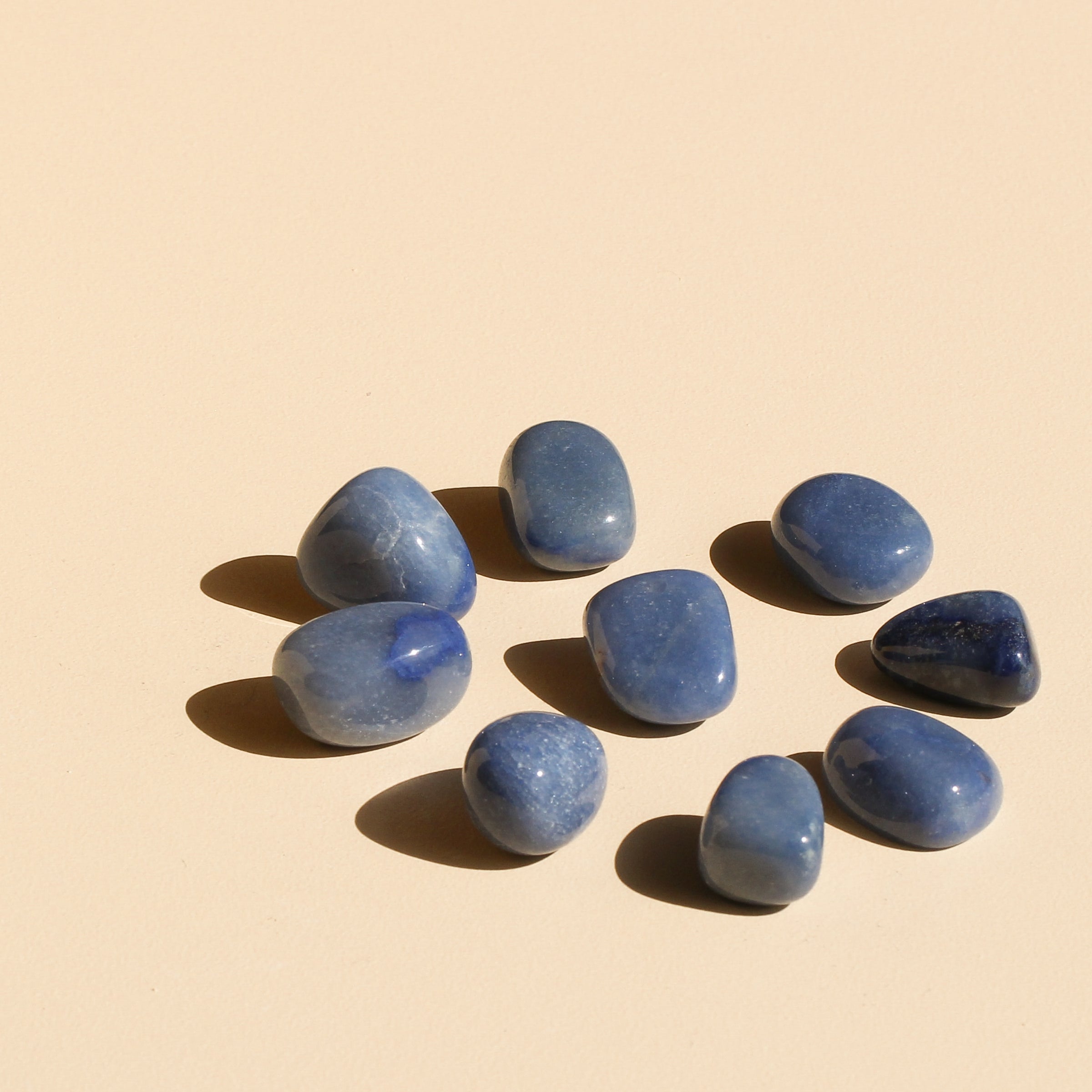 Blue Quartz Tumbles arranged in a circle with one tumble in the centre