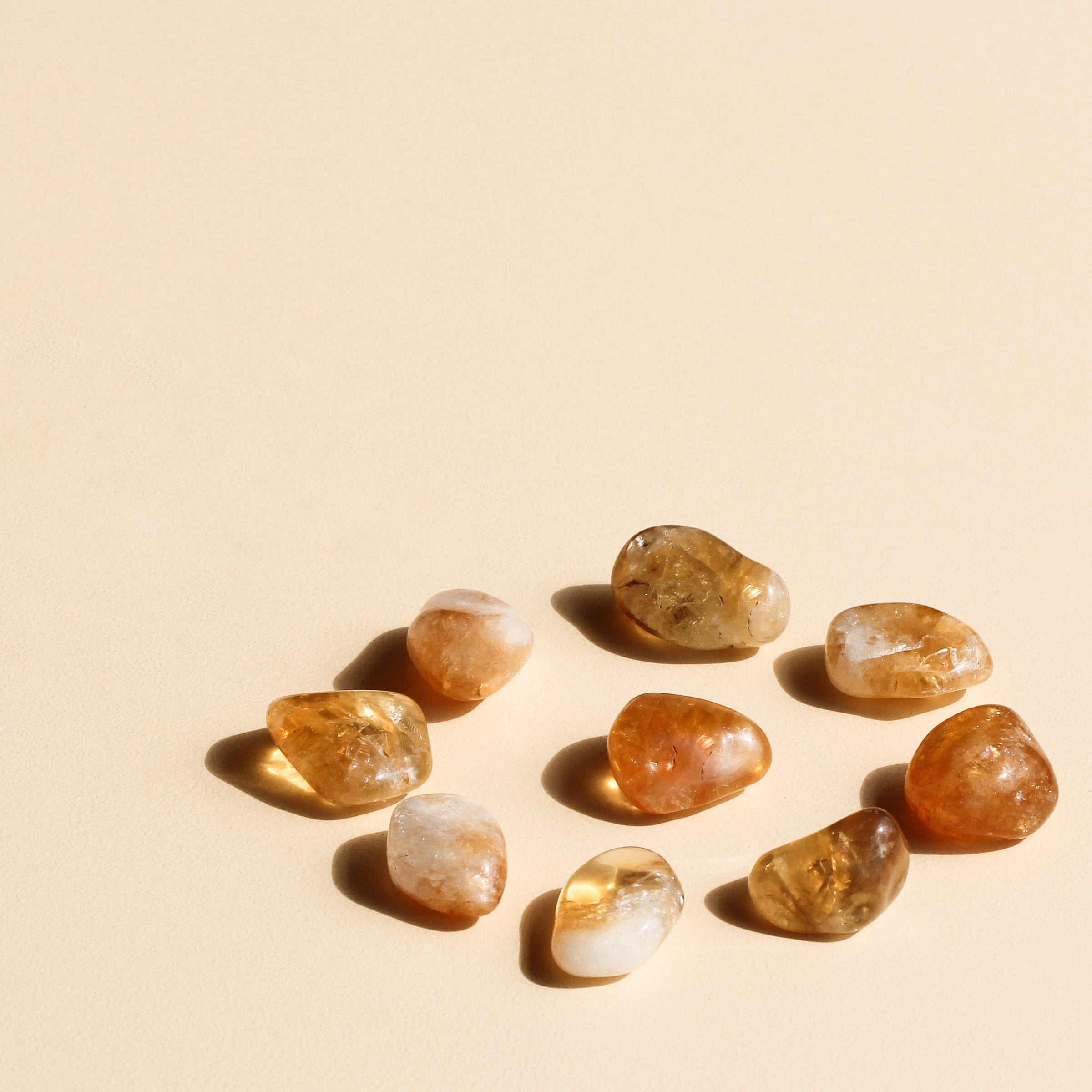 Citrine Tumbles arranged in a circle with one tumble in the centre