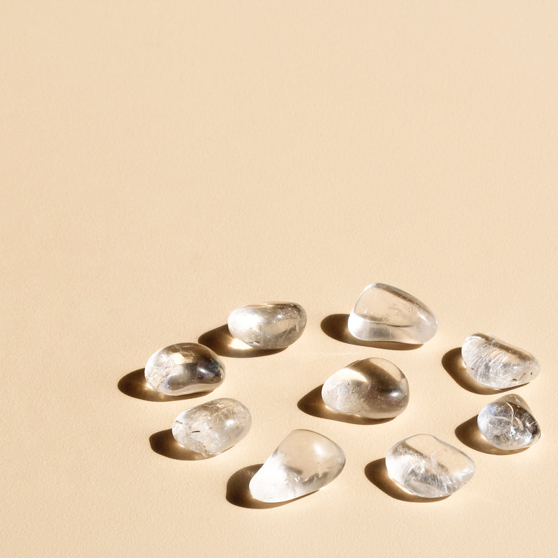 Clear Quartz Tumbles arranged in a circle with one tumble in the centre