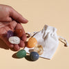 Crystal Chakra Set in variations of red aventurine, orange calcite, golden calcite, green aventurine, blue quartz, purple amethyst, and clear quartz, includes a bag