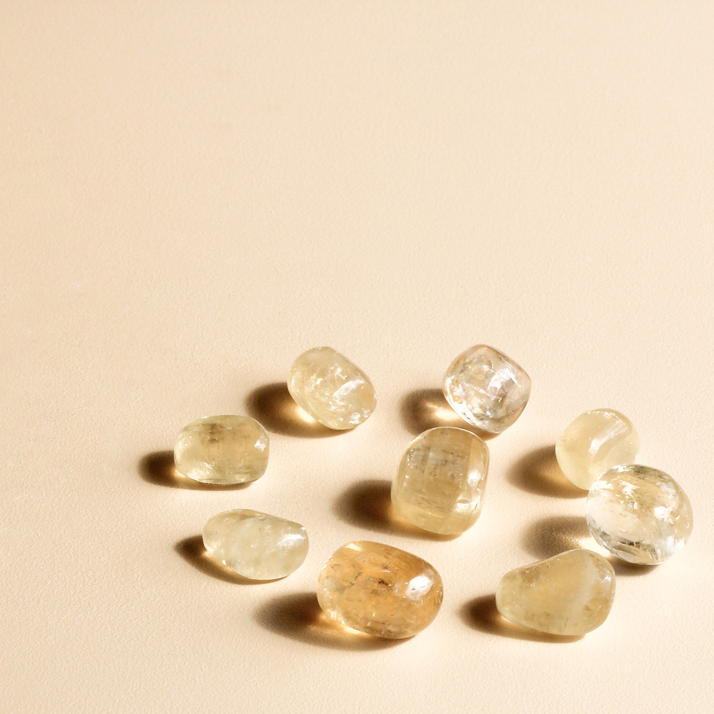 Golden Calcite Tumbles in a circle with a tumble in the centre