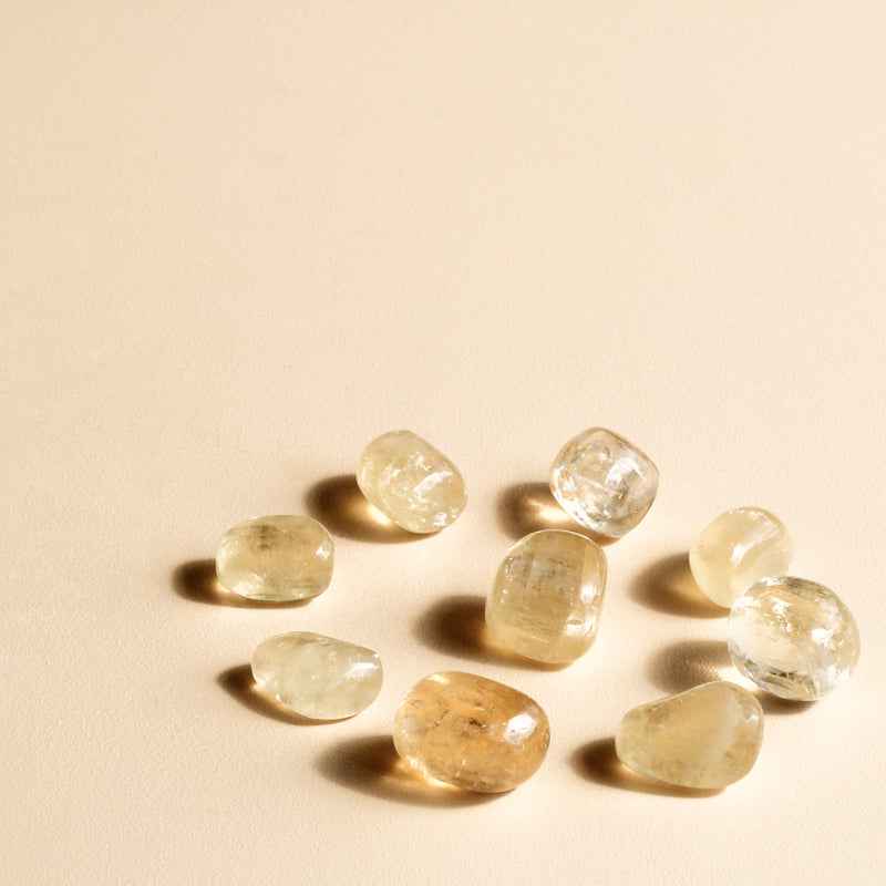 Golden Calcite Tumbles in a circle with a tumble in the centre