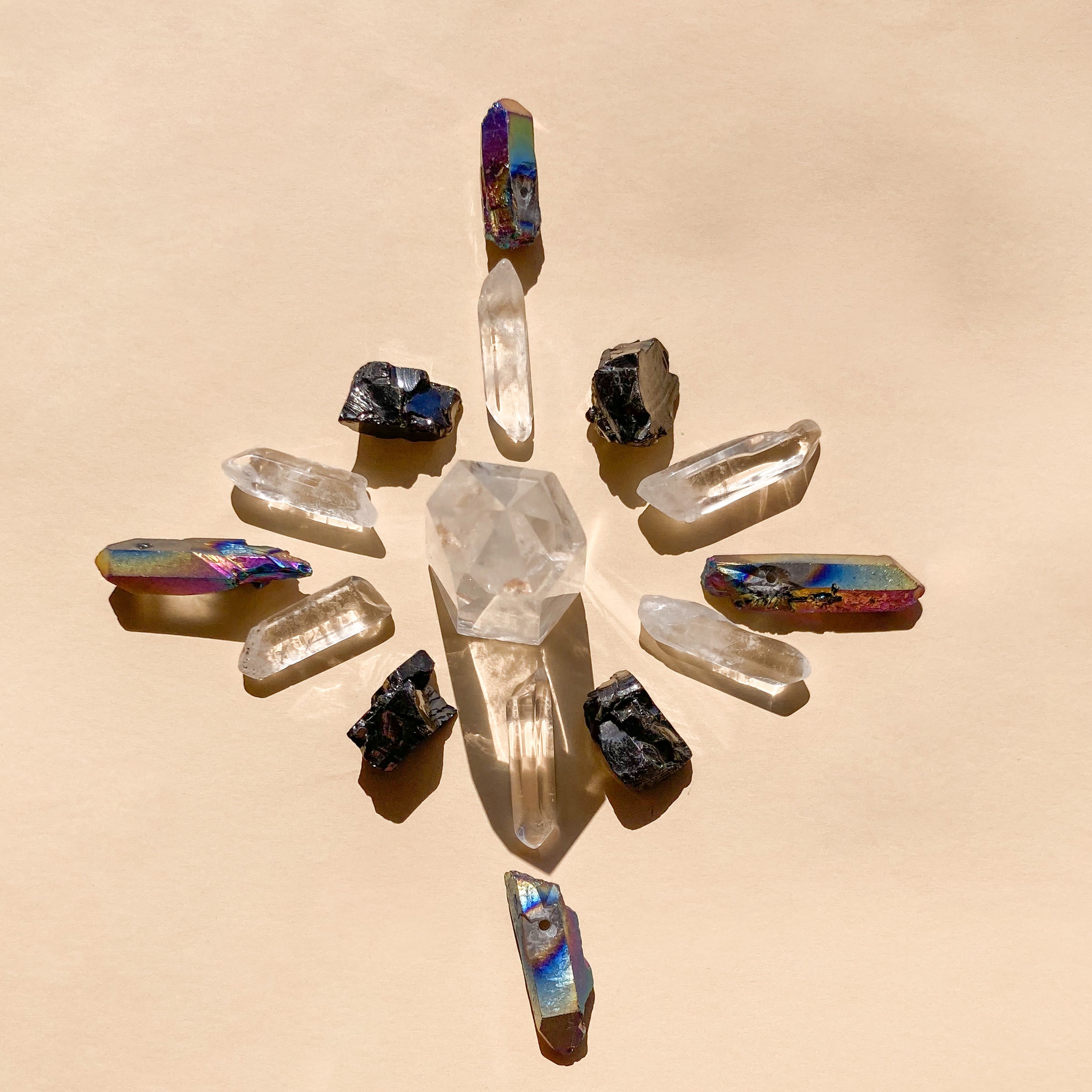 I Am Grounded & Protected features 1 medium Clear Quartz Point (5-6cm), 6 polished Clear Quartz points, 4 Elite Shungite pieces (1-2cm), and 4 Black Rainbow Aura Quartz necklace points, blending clarity, protection, and vibrant energy.