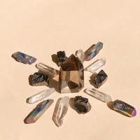 I Am Grounded & Protected features 1 medium Smokey Quartz Point (5-6cm), 6 polished Clear Quartz points, 4 Elite Shungite pieces (1-2cm), and 4 Black Rainbow Aura Quartz necklace points, blending clarity, protection, and vibrant energy.