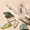 I Am Joyful & Abundant featuring a set of 1 medium Clear Quartz Point (5-6cm), 6 polished Clear Quartz points, 4 Fuschite pieces (2-3cm), and 4 Aura Quartz necklace points, combining prosperity, clarity, and healing energies