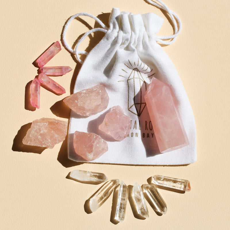 I Am Love & Light which contains 1 medium Rose Quartz Point (5-6cm), 6 polished Clear Quartz points, 4 rough Rose Quartz chunks (2-4cm), and 4 Pink Aura Quartz necklace points, offering a harmonious blend of love and clarity, including a bag