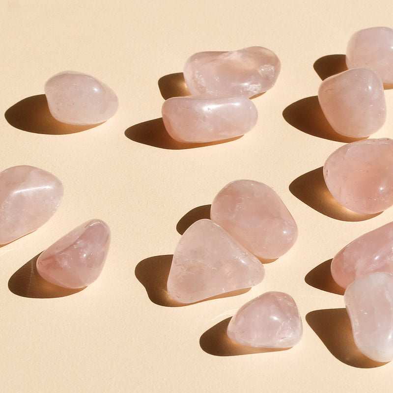 Rose Quartz Tumbles scattered around